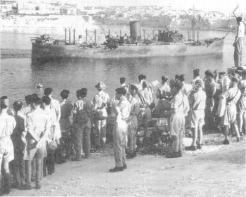 Army personnel watch the SS Melbourne Star enter Grand Harbour, Valletta